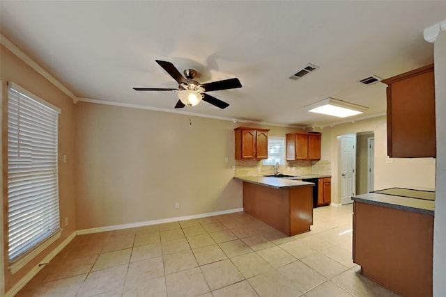 kitchen with sink, crown molding, light tile patterned floors, kitchen peninsula, and decorative backsplash