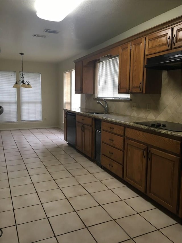 kitchen featuring sink, tasteful backsplash, hanging light fixtures, light tile patterned floors, and black appliances