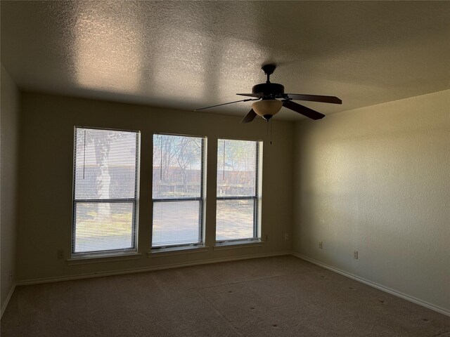 unfurnished living room featuring high vaulted ceiling, a fireplace, beam ceiling, and light carpet