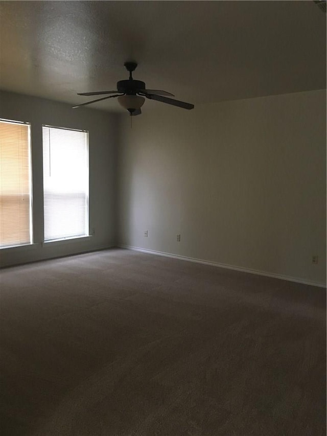 carpeted empty room with ceiling fan