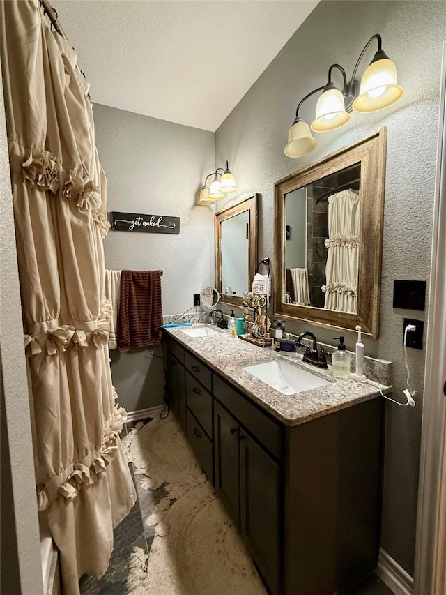 248 Mill, Emory, TX 75440 - full bath featuring double vanity, a textured wall, and a sink