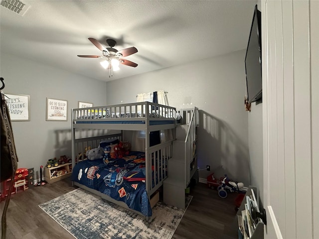 bedroom with dark hardwood / wood-style floors and a textured ceiling