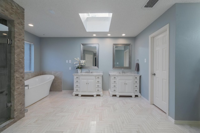 bathroom featuring parquet flooring, separate shower and tub, a skylight, a textured ceiling, and vanity