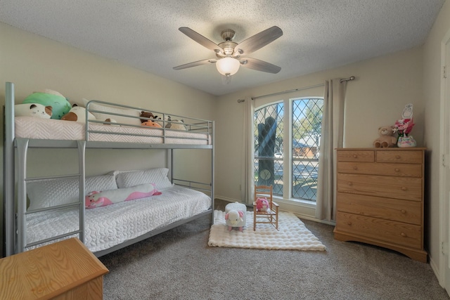 carpeted bedroom with a textured ceiling and ceiling fan