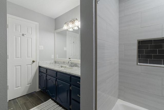 bathroom featuring vanity and a washtub