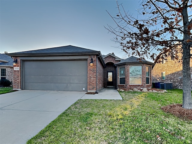 single story home featuring a garage and a front lawn