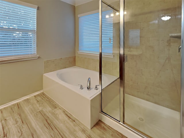 bathroom with wood-type flooring and plus walk in shower