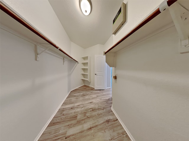 spacious closet with light hardwood / wood-style floors