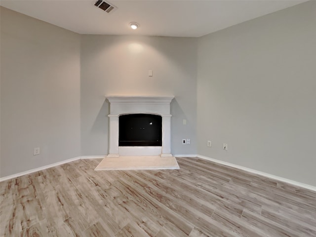 unfurnished living room with light hardwood / wood-style flooring