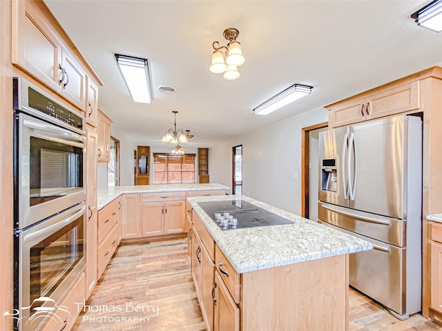 kitchen with kitchen peninsula, stainless steel appliances, an inviting chandelier, light brown cabinetry, and pendant lighting