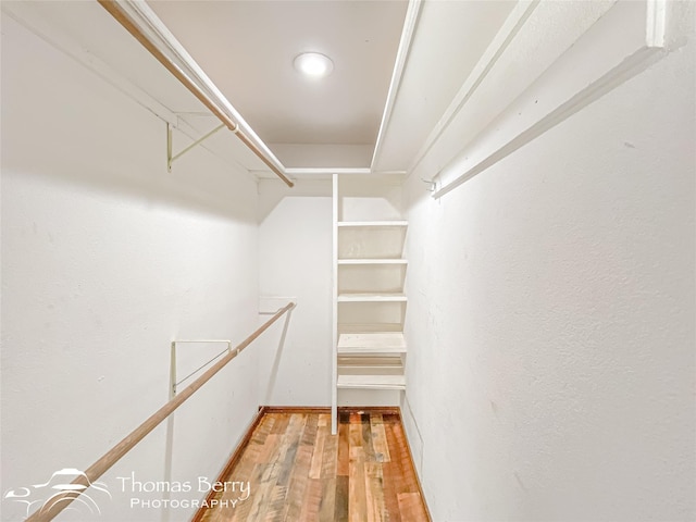 spacious closet featuring hardwood / wood-style flooring