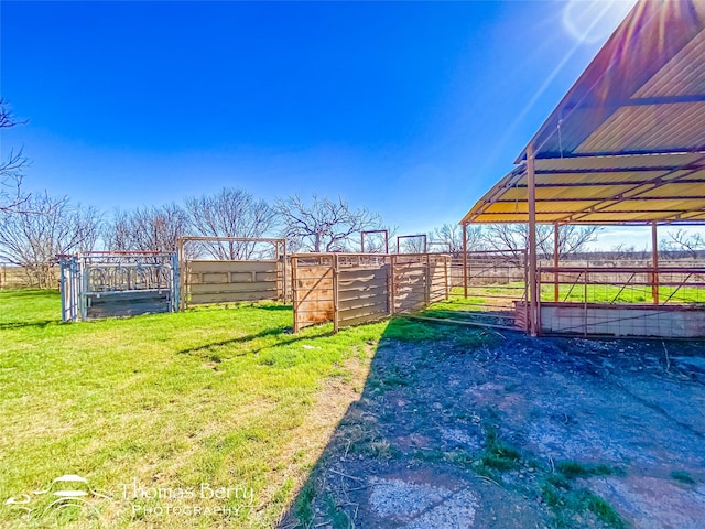 view of yard featuring a rural view and an outbuilding