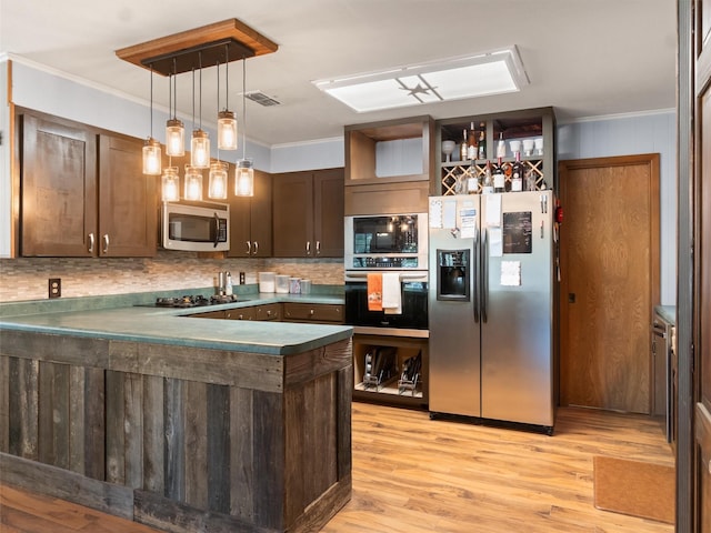 kitchen with black appliances, ornamental molding, dark brown cabinetry, kitchen peninsula, and light hardwood / wood-style flooring