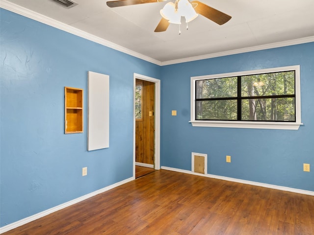 spare room featuring crown molding, ceiling fan, and dark hardwood / wood-style flooring