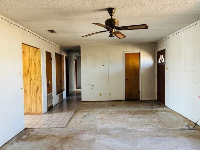 unfurnished bedroom with ceiling fan, concrete flooring, and a textured ceiling