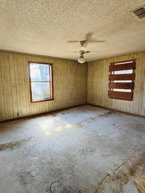 unfurnished room featuring ceiling fan and a textured ceiling