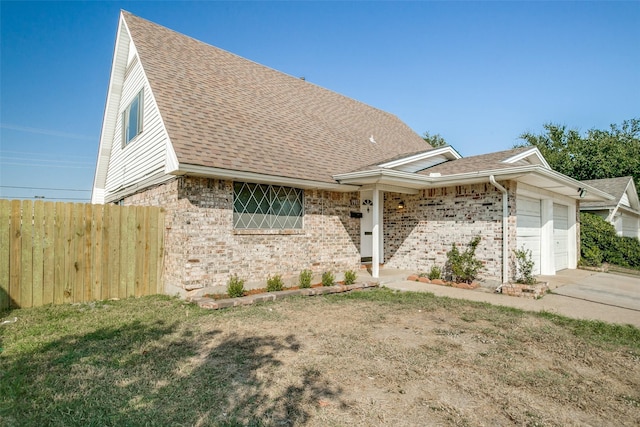 view of front facade with a garage and a front lawn