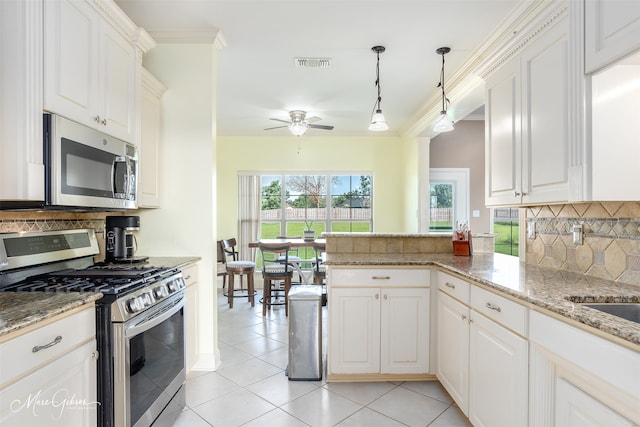 kitchen featuring pendant lighting, stainless steel appliances, tasteful backsplash, white cabinets, and kitchen peninsula