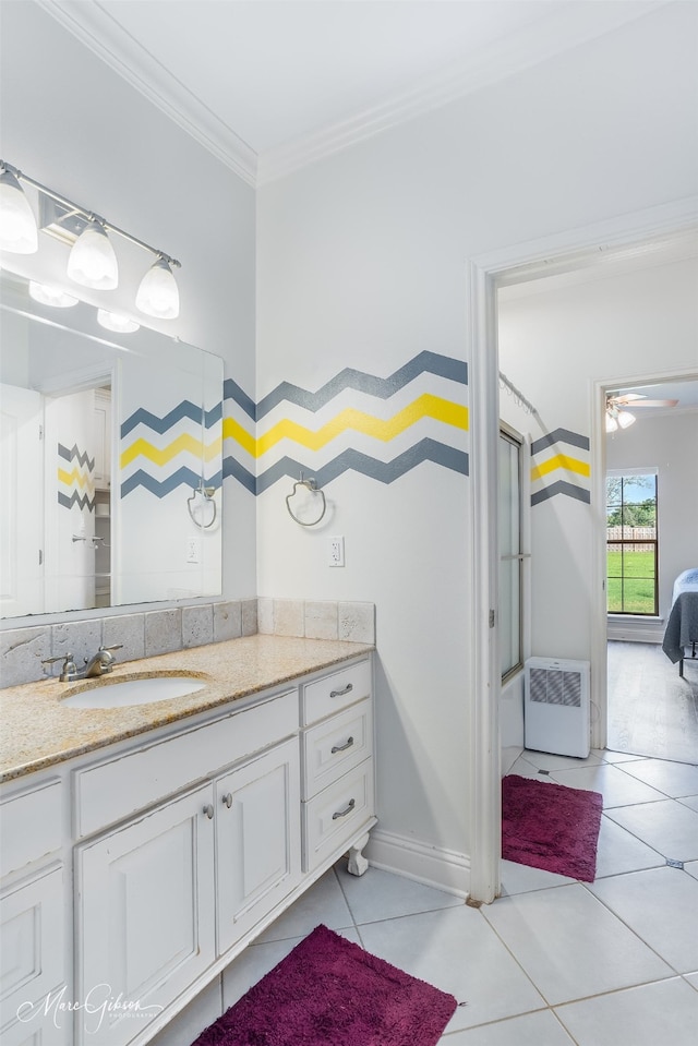 bathroom with tile patterned flooring, vanity, and crown molding