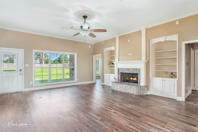 unfurnished living room with ornamental molding, dark hardwood / wood-style flooring, and built in features