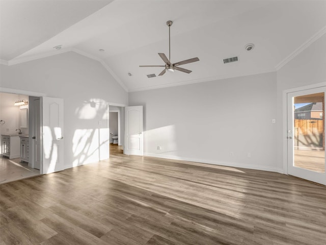 unfurnished living room with wood-type flooring, lofted ceiling, and ornamental molding