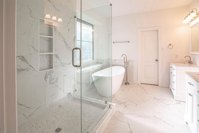 bathroom with vanity and separate shower and tub