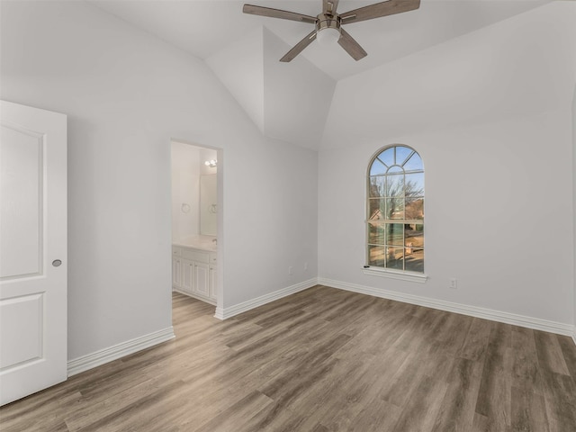 empty room featuring vaulted ceiling, ceiling fan, and light hardwood / wood-style floors