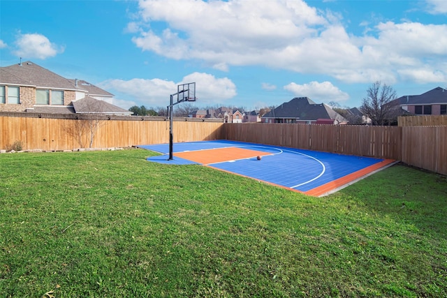 view of basketball court with a yard