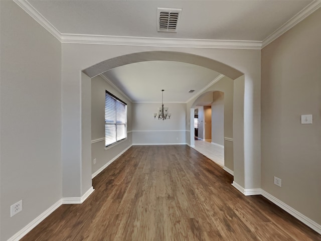 unfurnished dining area featuring ornamental molding, a notable chandelier, and dark hardwood / wood-style flooring