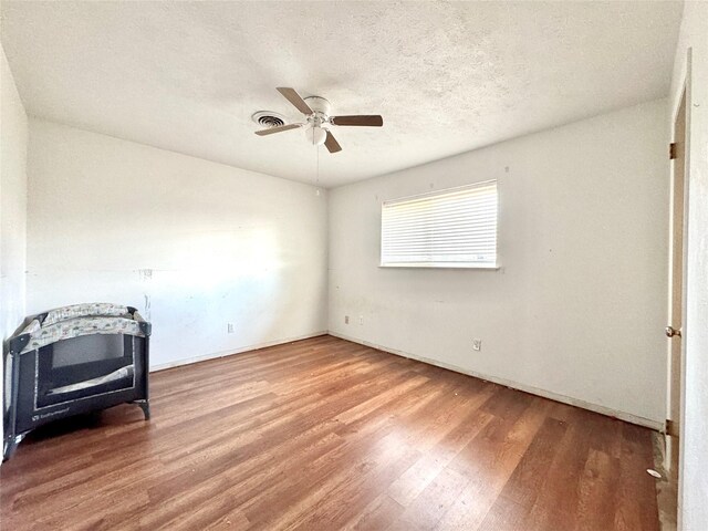 2304 Royal Acres Dr, Denton, TX 76209 - living room featuring ceiling fan, hardwood / wood-style floors, and a textured ceiling