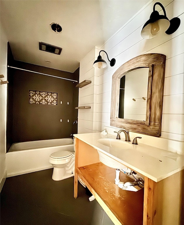 2304 Royal Acres Dr, Denton, TX 76209 - full bathroom featuring vanity, shower / bathing tub combination, wooden walls, and toilet