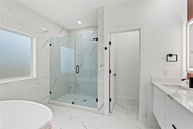 bathroom featuring vanity and separate shower and tub