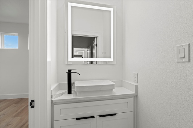 bathroom with hardwood / wood-style flooring and vanity