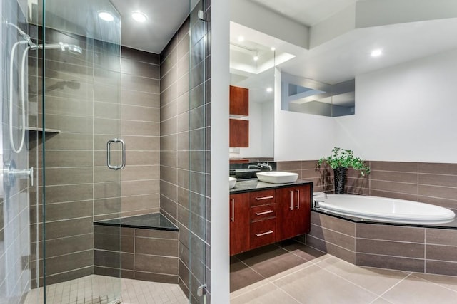 bathroom with tile patterned flooring, vanity, and plus walk in shower