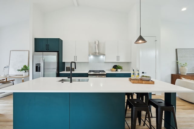 2138 Lovedale Ave Unit 105, Dallas, TX 75235 - kitchen featuring wall chimney exhaust hood, a sink, light wood-type flooring, high vaulted ceiling, and appliances with stainless steel finishes