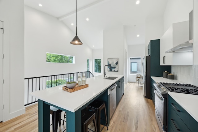 2138 Lovedale Ave Unit 105, Dallas, TX 75235 - kitchen with wall chimney range hood, stainless steel appliances, a sink, and high vaulted ceiling