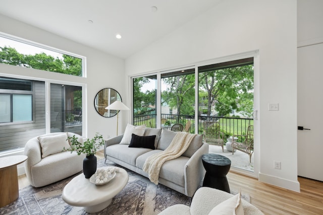 2138 Lovedale Ave Unit 105, Dallas, TX 75235 - living area featuring high vaulted ceiling, baseboards, a healthy amount of sunlight, and light wood-type flooring