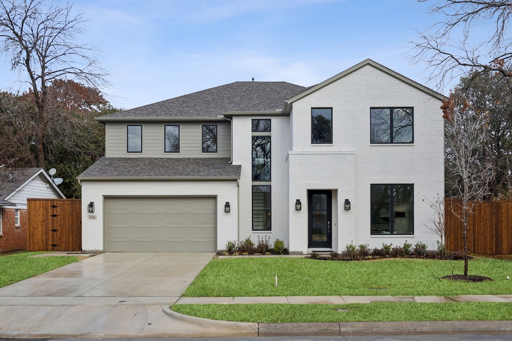 view of front facade with a garage and a front lawn