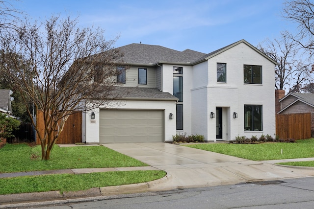 view of front of home with a garage and a front yard