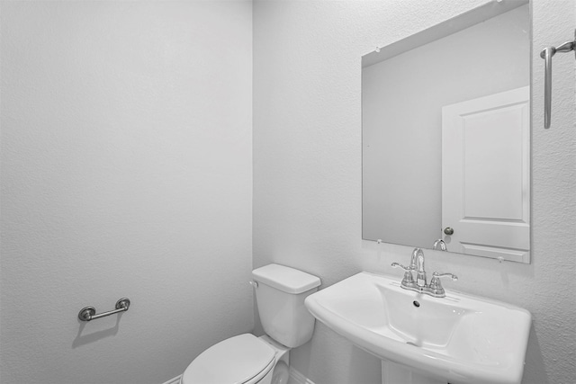 bathroom with sink and toilet