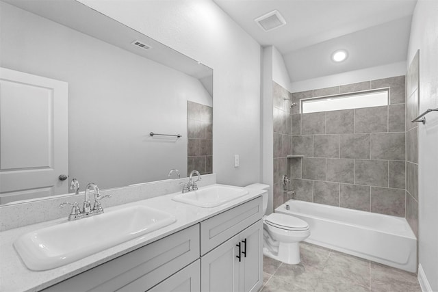 full bathroom with vanity, tile patterned flooring, toilet, and tiled shower / bath