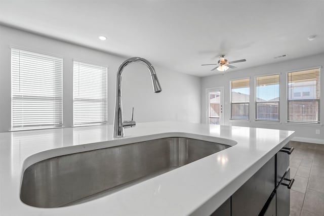 interior details with ceiling fan and sink