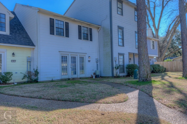 view of front of home featuring a front yard and french doors