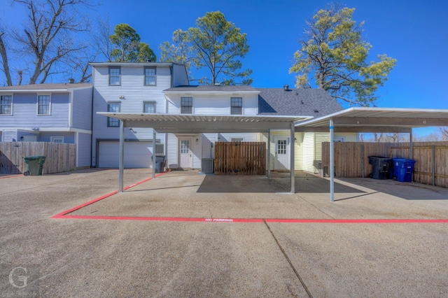 back of property with a carport and a garage