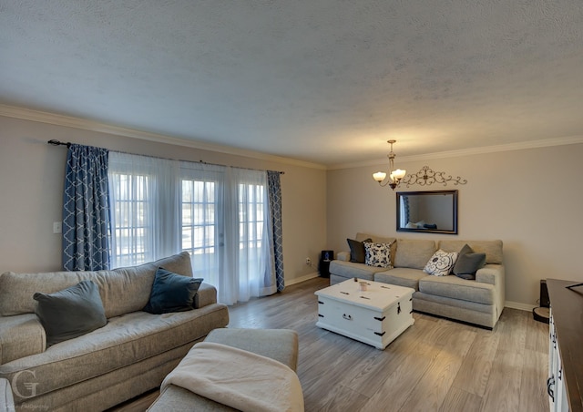 living room with ornamental molding, a chandelier, a textured ceiling, and light hardwood / wood-style floors