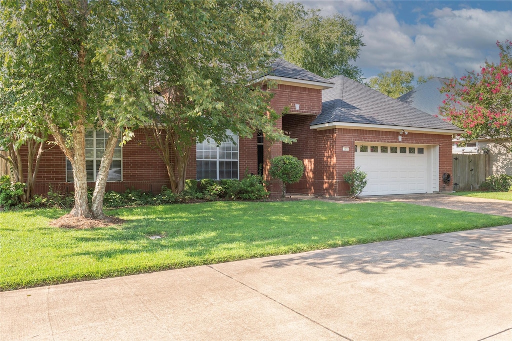 view of front of property with a garage and a front yard