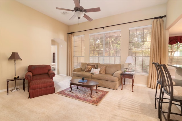 living room featuring light carpet and ceiling fan