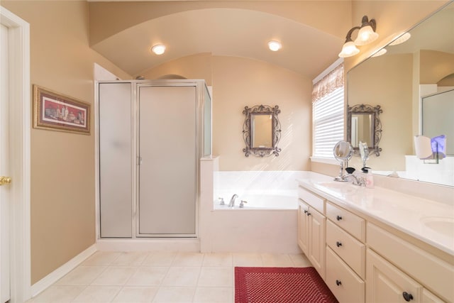 bathroom with tile patterned flooring, vanity, vaulted ceiling, and independent shower and bath