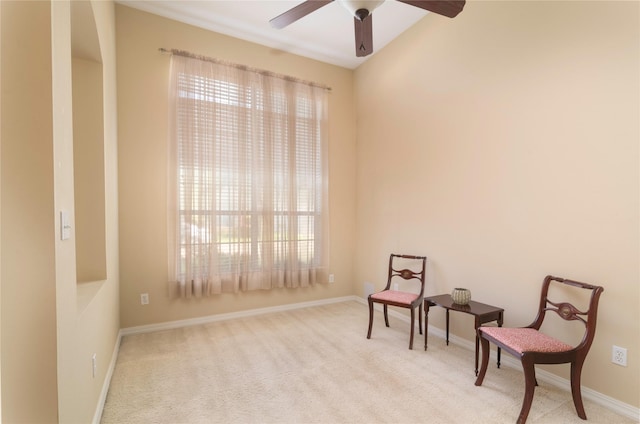 sitting room with a healthy amount of sunlight, light carpet, and ceiling fan