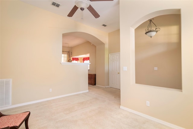 carpeted spare room with ceiling fan